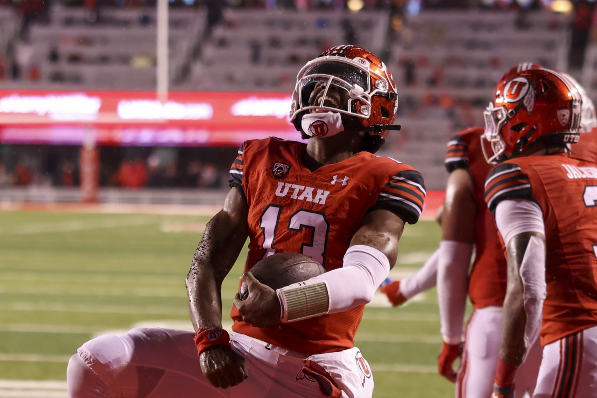 Utah Utes quarterback Nate Johnson (13) celebrates a touchdown against the Arizona Wildcats in the second quarter at Rice-Eccles Stadium.
